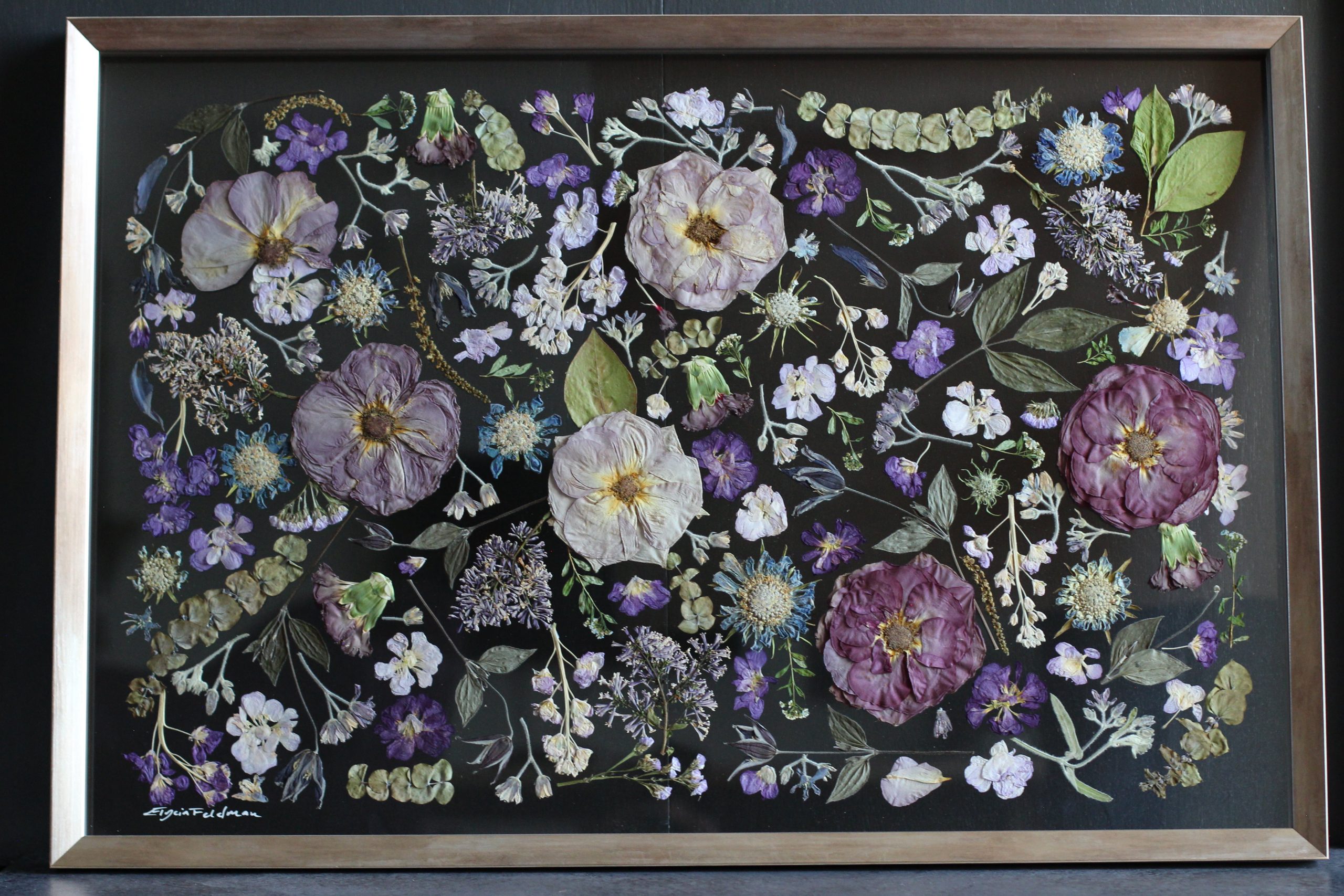 pressed floral preservation art in a botanical design using shades of purple flowers