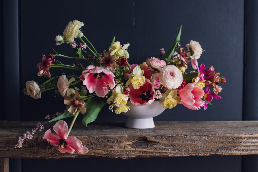 pink-spring-bouquet-and-centerpiece-web-61 pink tulips and yellow daffodil spring flowers arranged in a white bowl