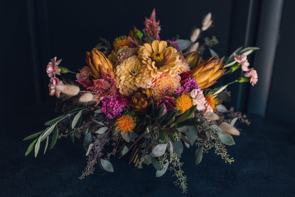 garden style bouquet of golden zinnia and wild elements