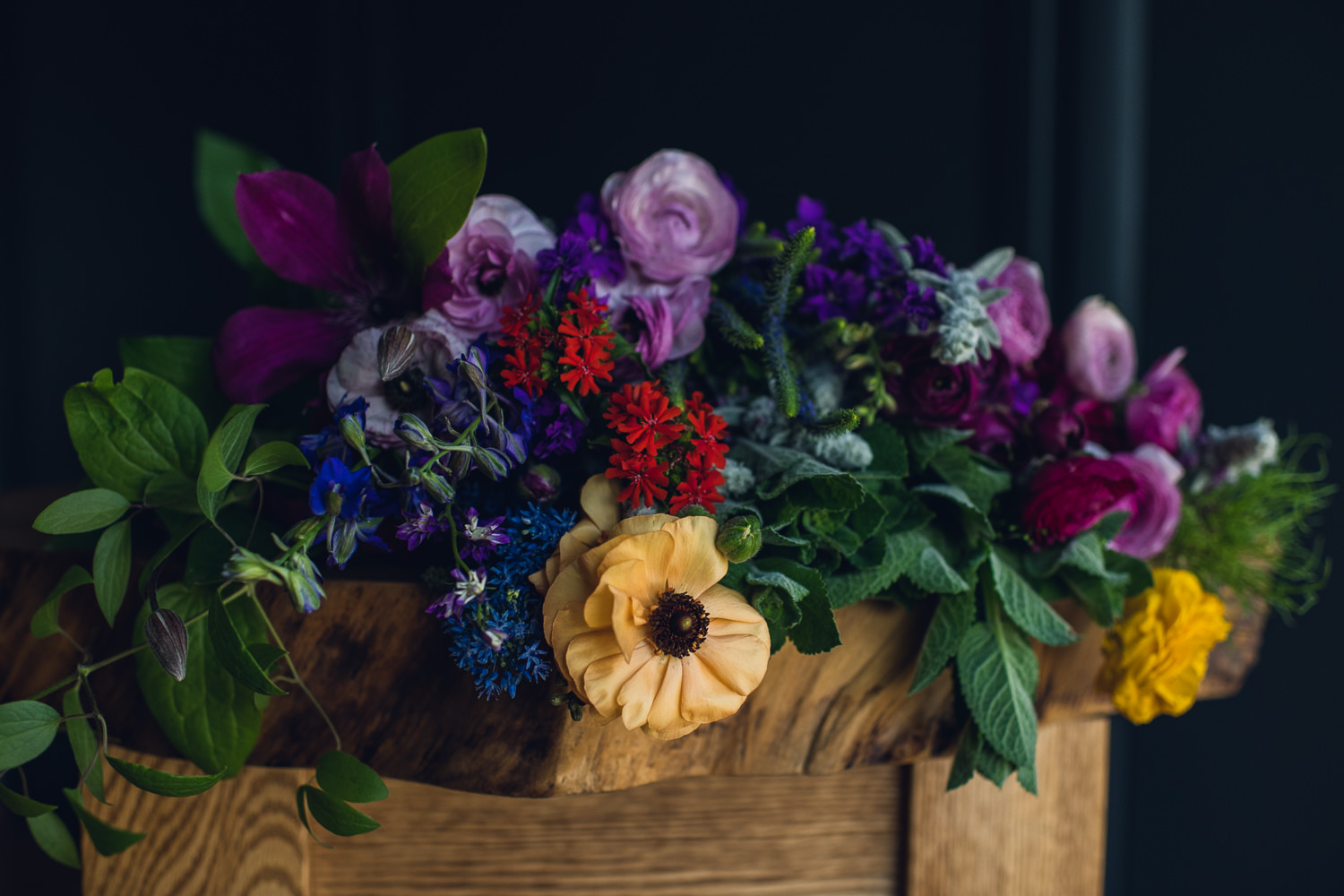 vibrant summer flowers laying on a wood table