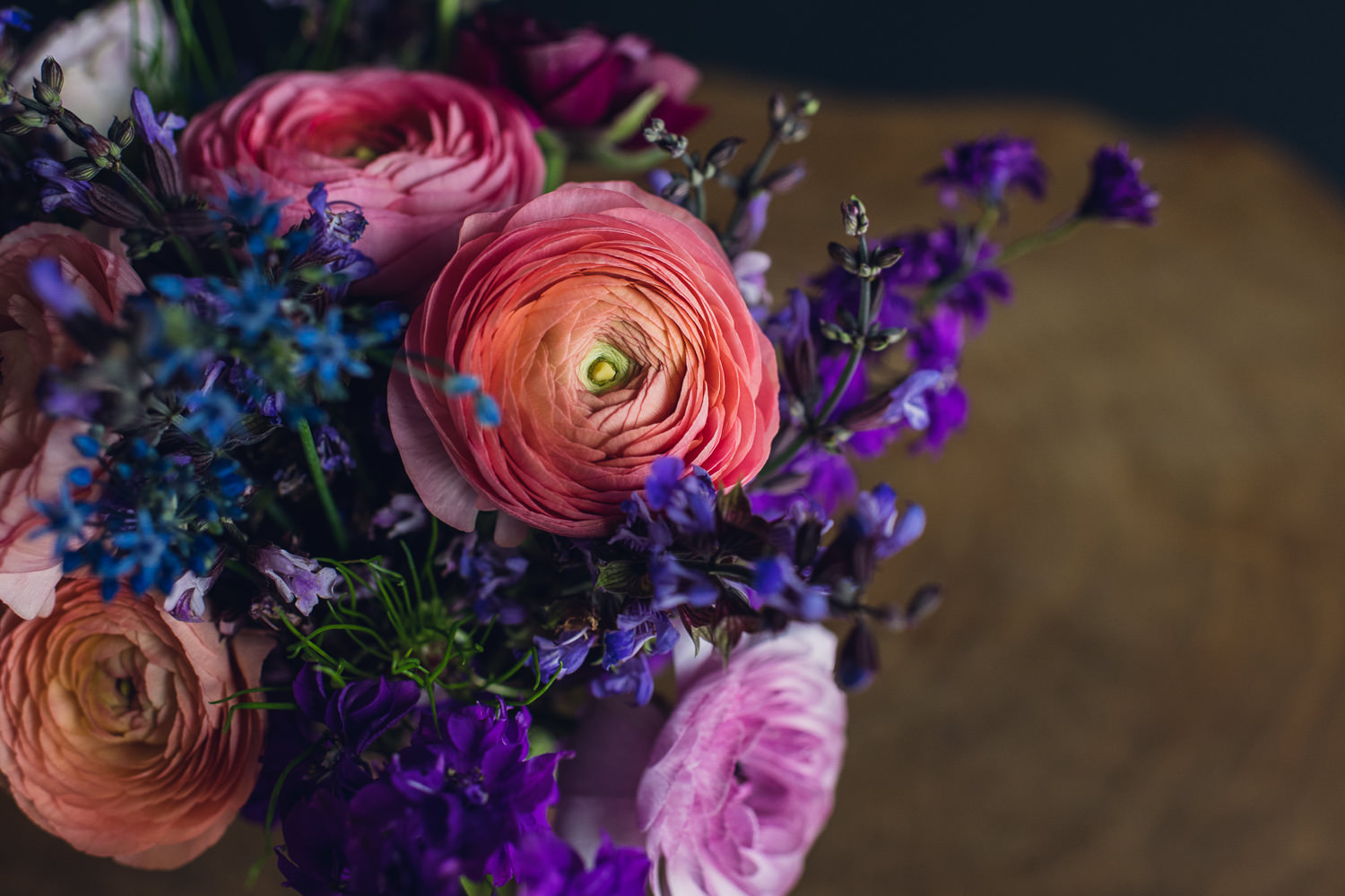 vibrant ranunculus bouquet with allium and larkspur
