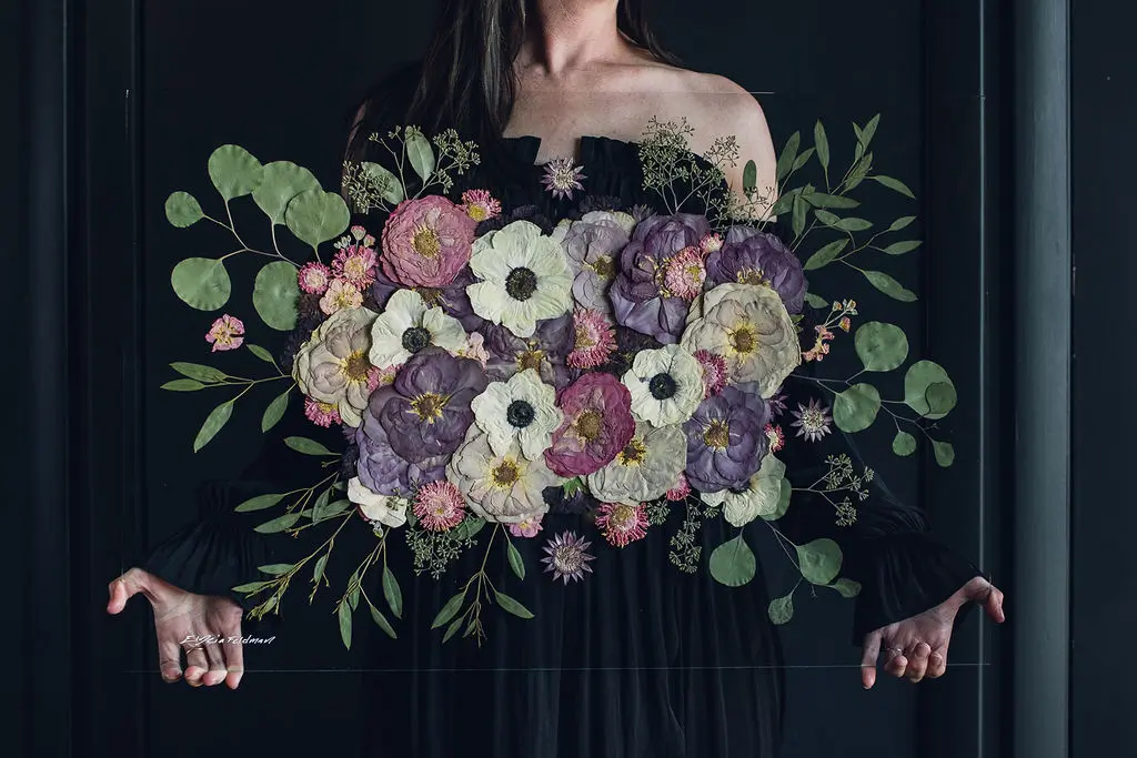 White, pink, and purple pressed flower art.