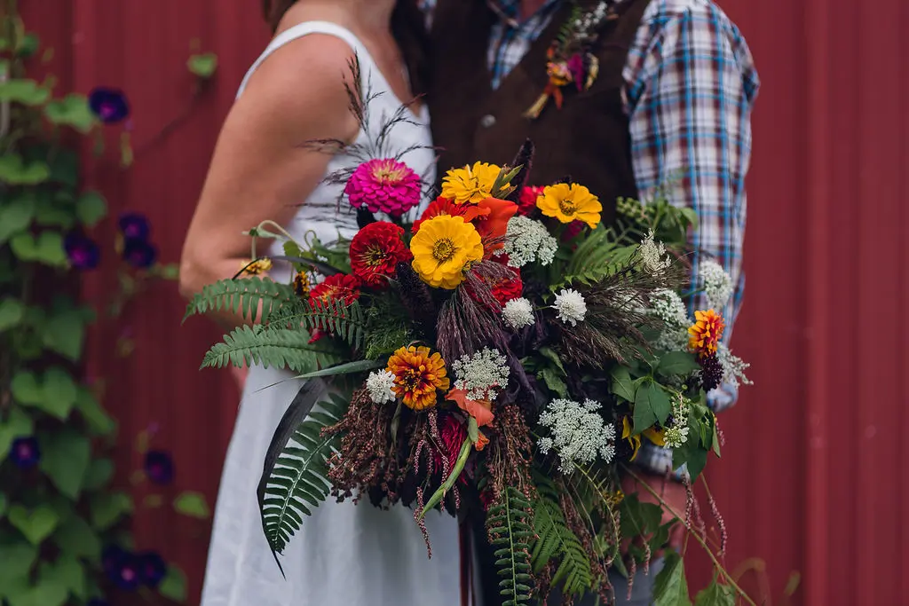 websize-7731 Big Magic, Melody photographing Elycia's garden style bouquet with bride and groom in upsate New York