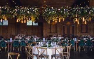 lush hanging wedding floral installation over reception tables