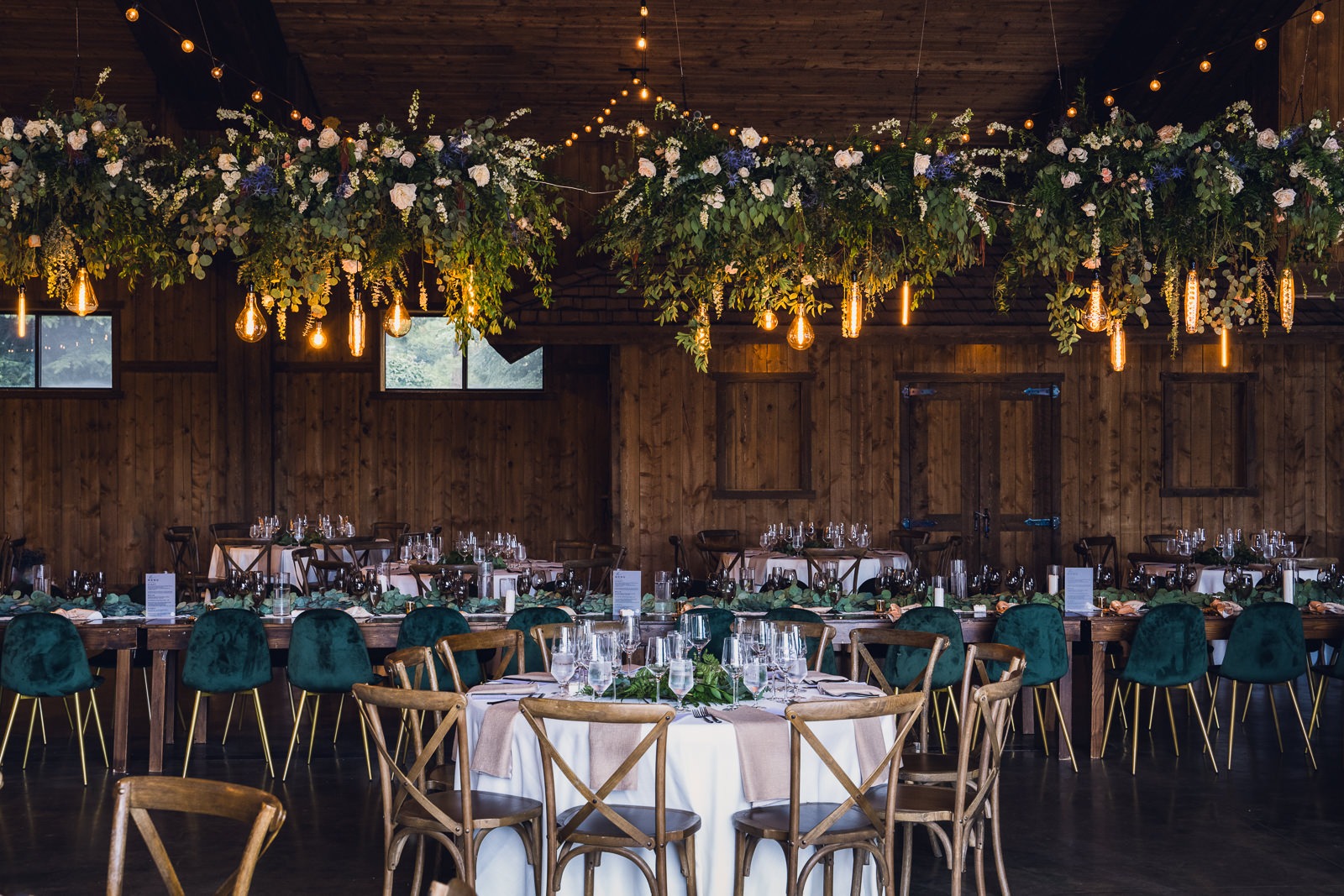 lush hanging wedding floral installation over reception tables