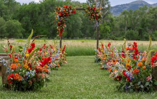 vibrant colorado wedding flowers for aisle and ceremony