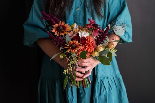 woman holding autumn bouquet
