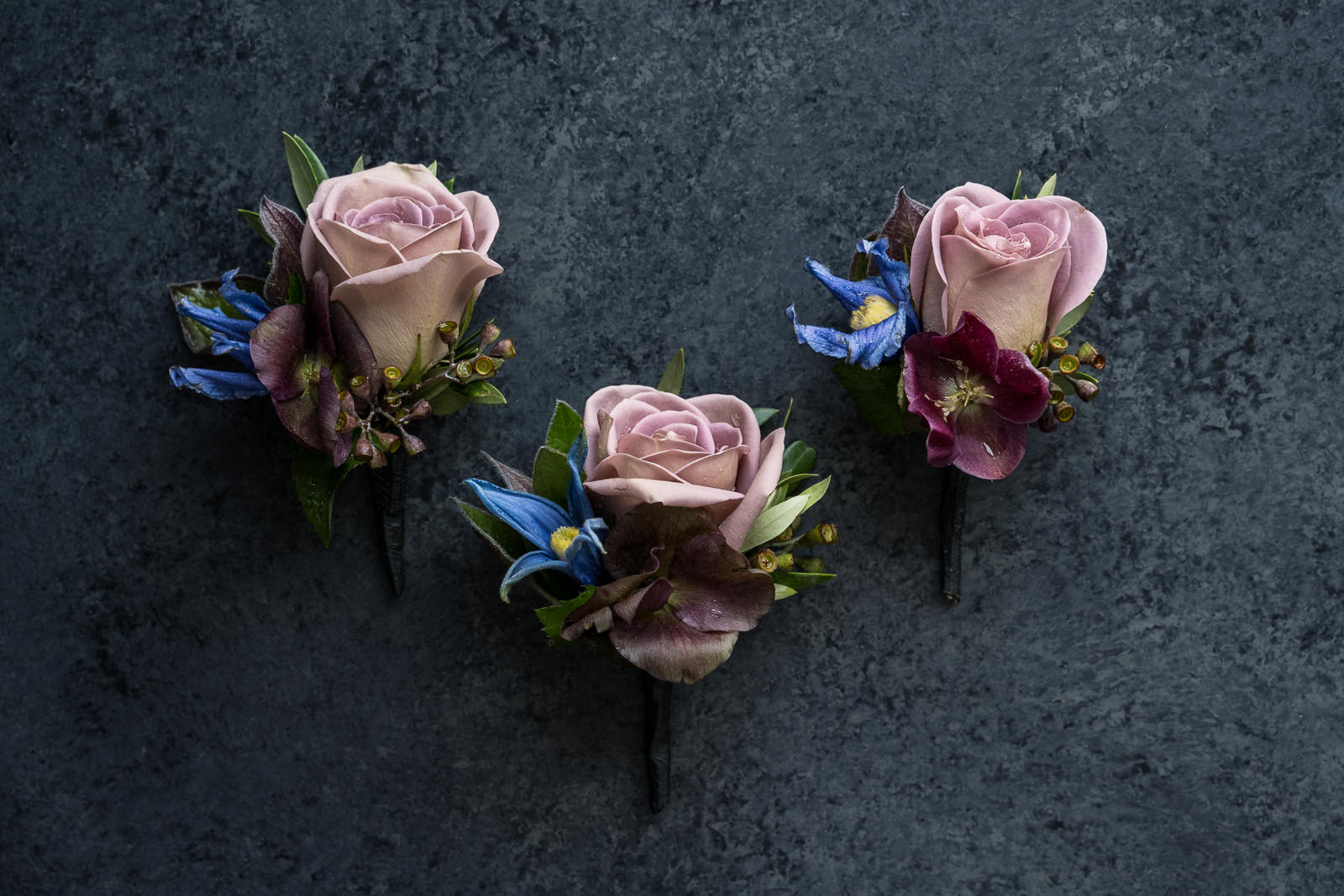 three floral boutonnieres with focal pink rose for colorado wedding