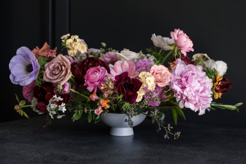 medium centerpiece full of pastel flowers for colorado wedding
