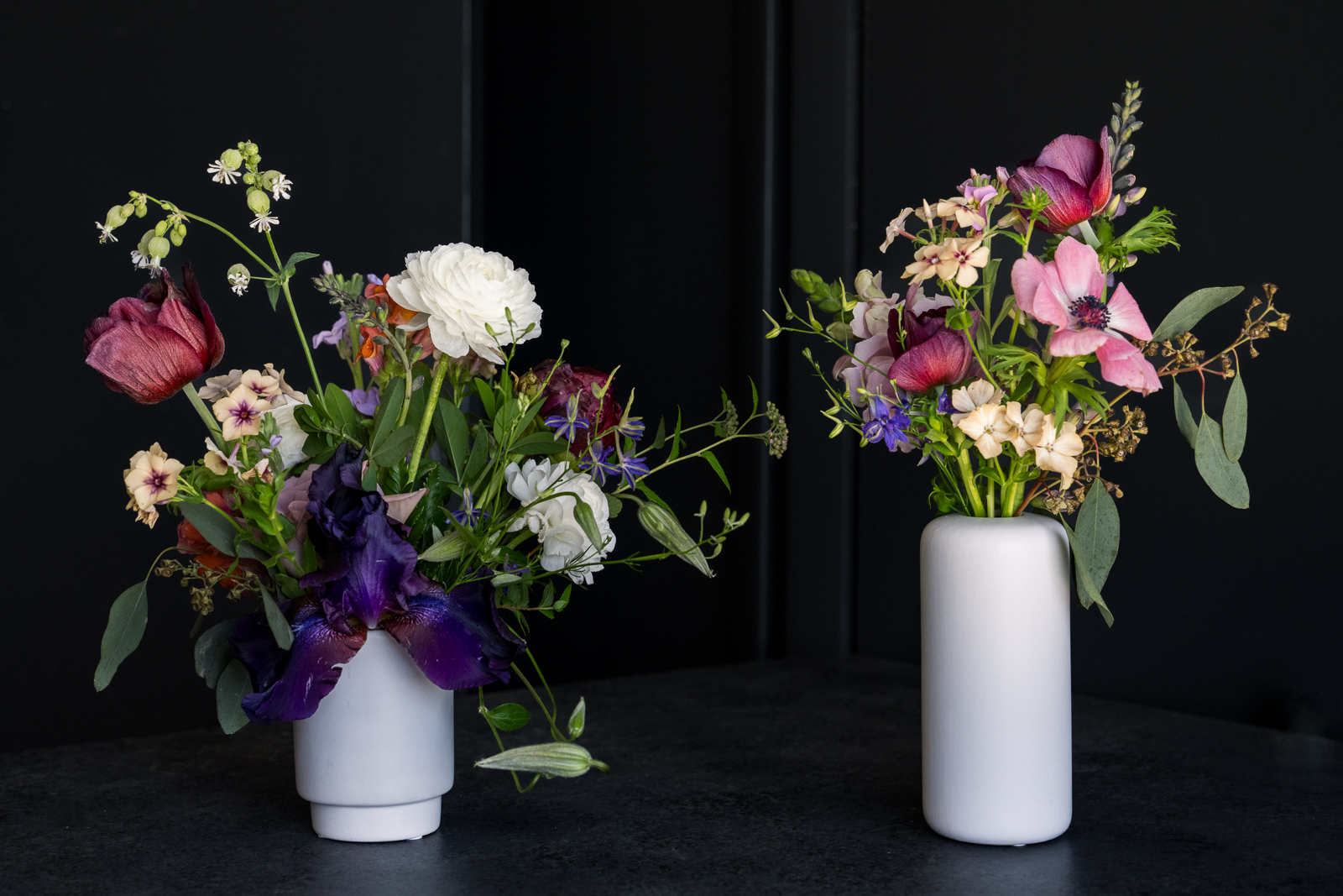 two white ceramic bud vases full of flowers for colorado wedding